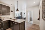 Spacious kitchen with granite countertops and high-end appliances